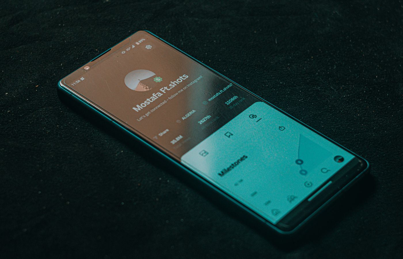 Smartphone displaying a mobile app interface on a dark surface