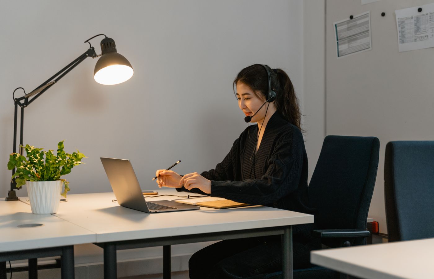 Support specialist using a laptop and headset