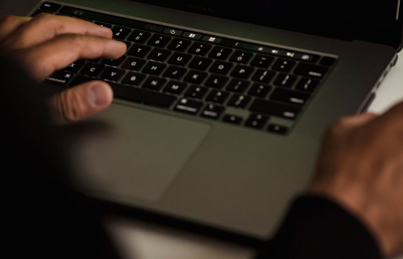 Hands using a laptop keyboard, illustrating a security workflow