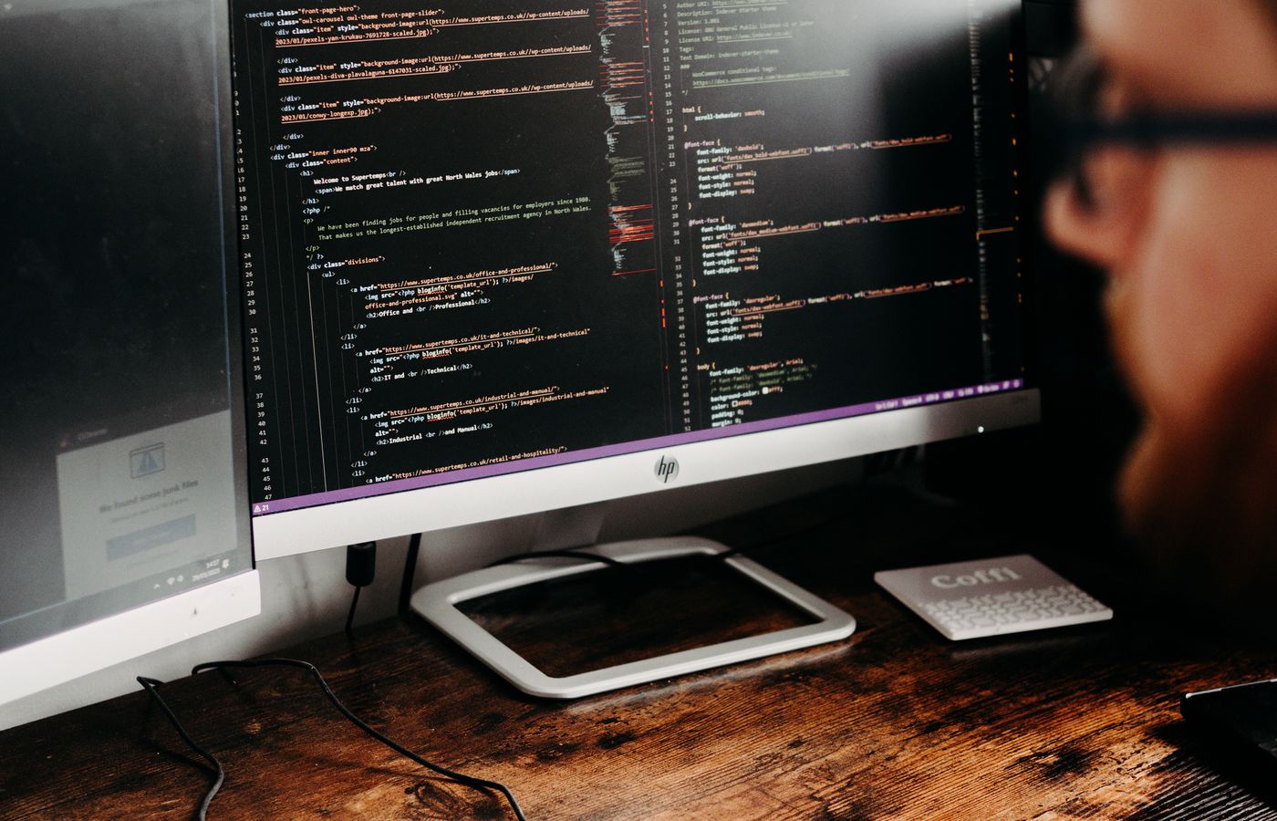 Developer reviewing source code on a desktop monitor